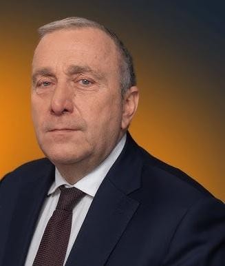 Grzegorz Schetyna podczas spotkania z wyborcami, uśmiechnięty i zaangażowany w interakcję z tłumem.